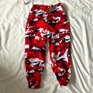 Red, white, and black camo pants, not worn, size medium, has belt loops as well.